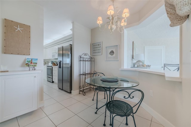 tiled dining room featuring a chandelier