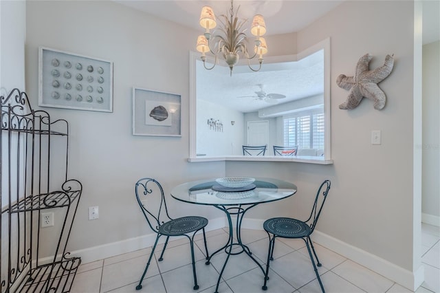 tiled dining area featuring ceiling fan with notable chandelier and a textured ceiling