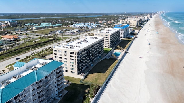 aerial view with a water view and a beach view