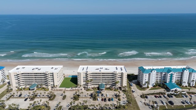 drone / aerial view featuring a water view and a view of the beach