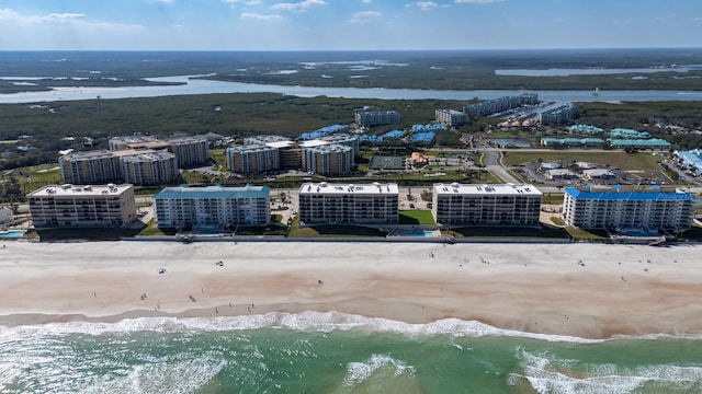 birds eye view of property featuring a water view and a view of the beach