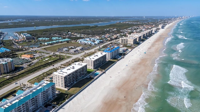 drone / aerial view featuring a water view and a beach view