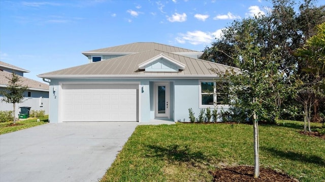 view of front of house with a garage and a front yard