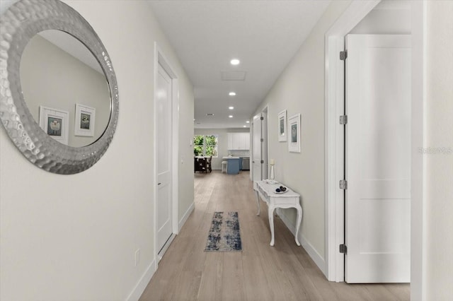 corridor with light hardwood / wood-style flooring