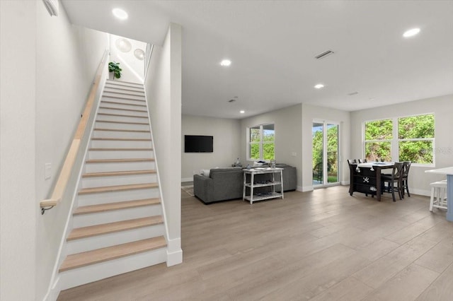 stairs featuring hardwood / wood-style floors