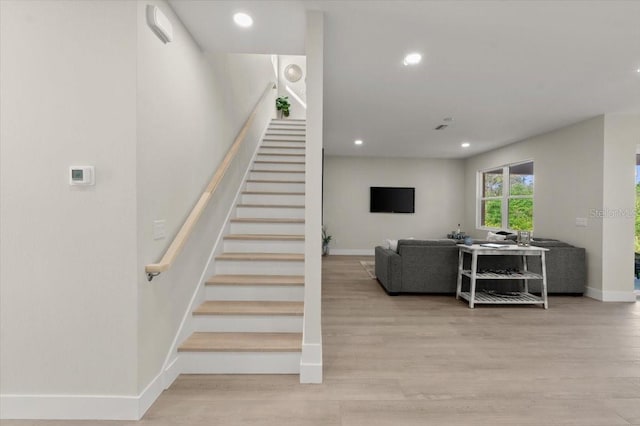 stairway featuring wood-type flooring