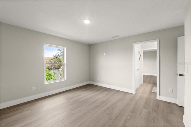 unfurnished room with light hardwood / wood-style flooring