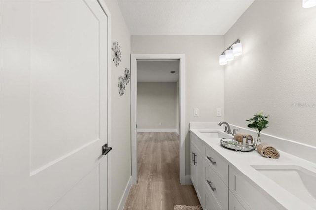 bathroom with vanity, hardwood / wood-style floors, and a textured ceiling