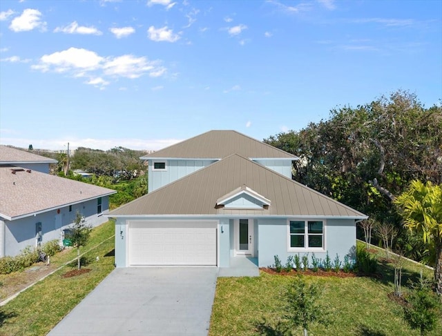 72 Aurora Ave, Ponce Inlet, FL 32127 - view of front facade with a garage, concrete driveway, a standing seam roof, and a front lawn