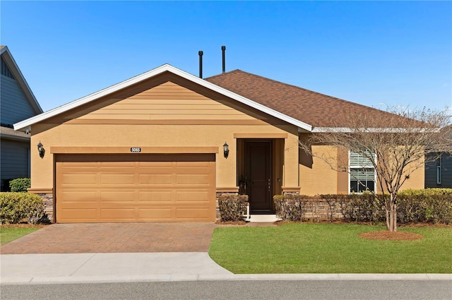 ranch-style house with a garage and a front yard