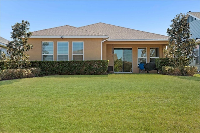 rear view of property with a lawn