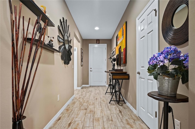 corridor with light hardwood / wood-style floors