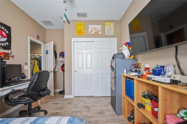 office space with light hardwood / wood-style flooring and a textured ceiling