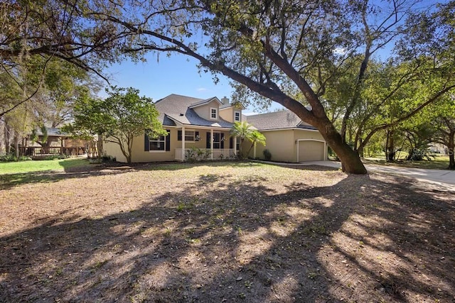 view of front of house featuring a garage, driveway, and stucco siding