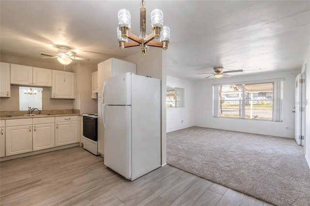 kitchen with sink, hanging light fixtures, light carpet, white appliances, and white cabinets