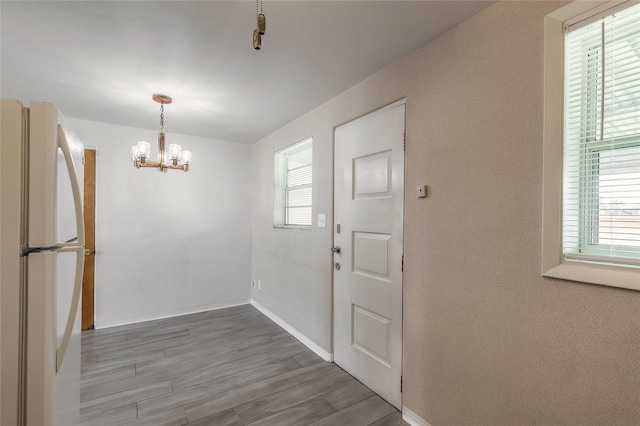 interior space featuring hardwood / wood-style floors and a notable chandelier