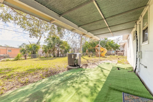 view of yard with a playground and central air condition unit