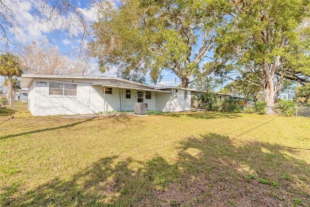 rear view of property with a yard