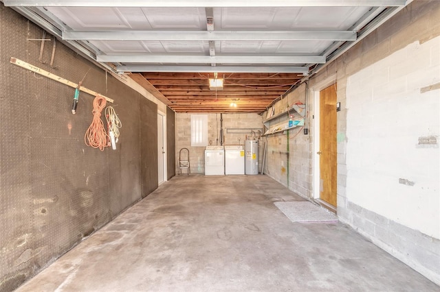 garage with independent washer and dryer and electric water heater