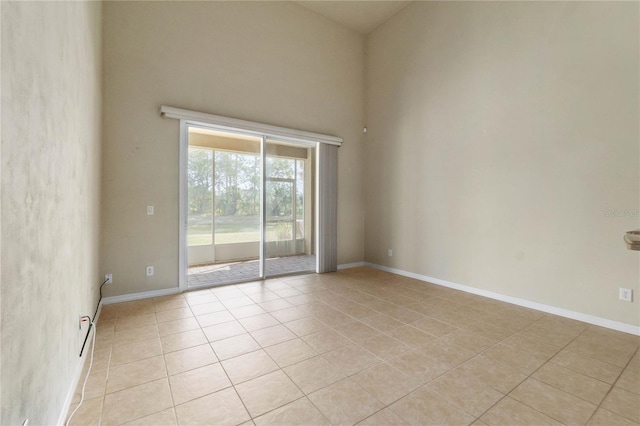 tiled empty room with a high ceiling