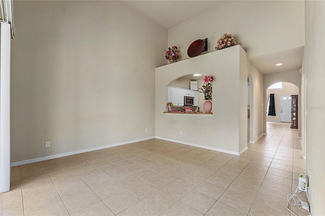 tiled empty room with high vaulted ceiling