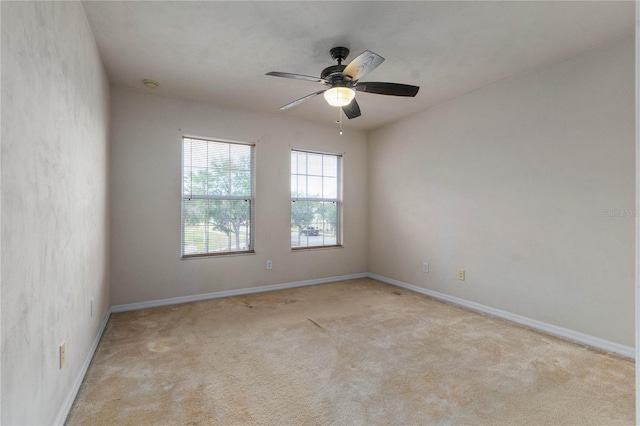 unfurnished room featuring ceiling fan and light carpet