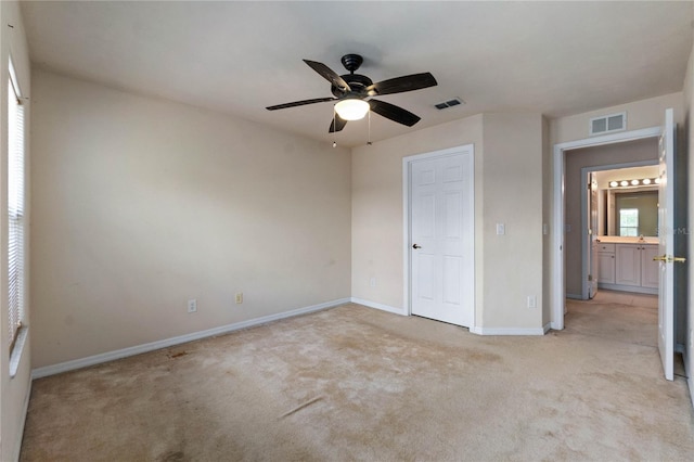 unfurnished bedroom with light carpet and ceiling fan