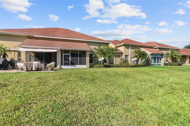 rear view of property with a lawn