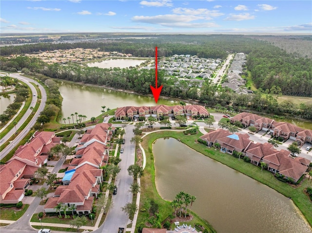 birds eye view of property with a water view