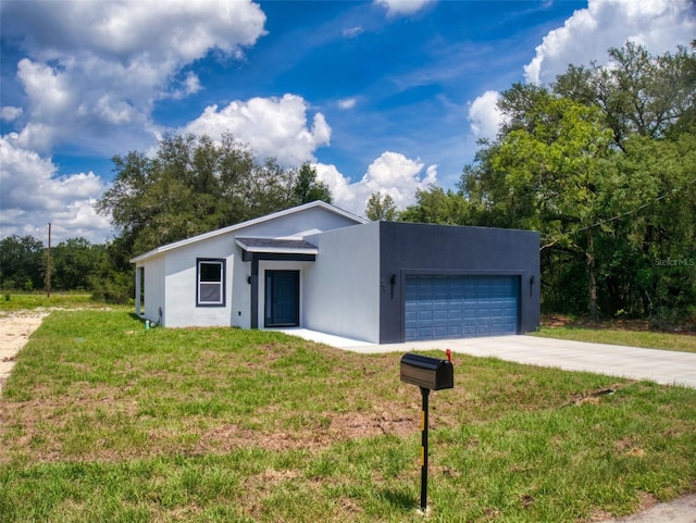 view of front of property with a garage and a front lawn