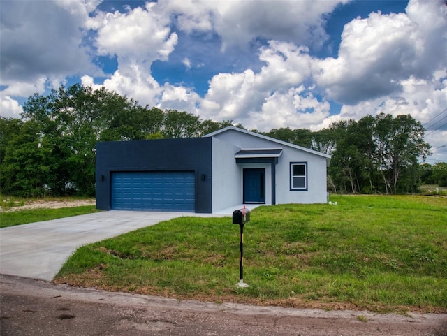 view of front facade with driveway, a front lawn, a garage, and stucco siding