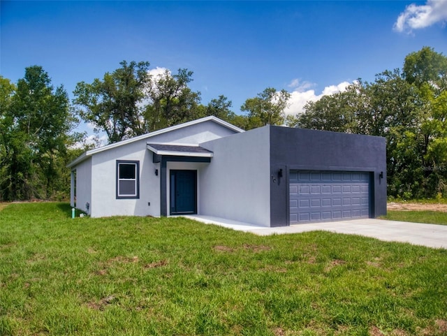 view of front facade featuring driveway, a front lawn, a garage, and stucco siding
