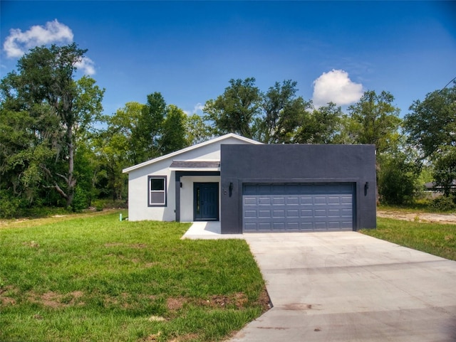 view of front of property with an attached garage, driveway, stucco siding, and a front yard