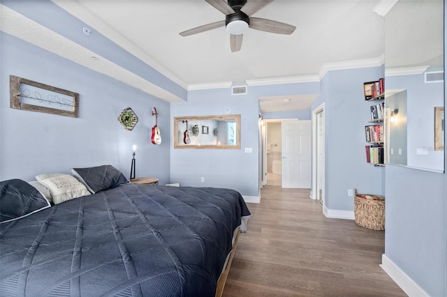 bedroom featuring ornamental molding, hardwood / wood-style floors, and ceiling fan