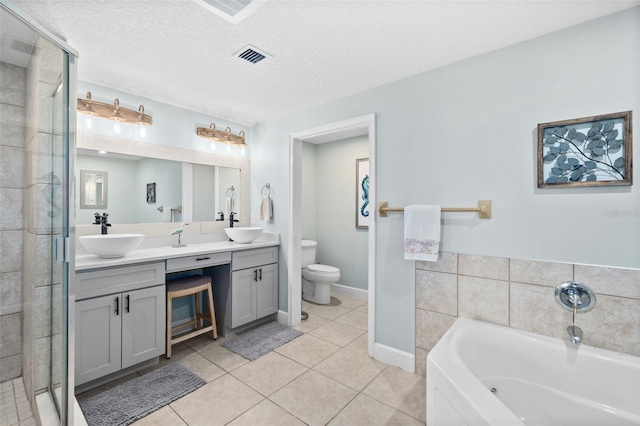 full bathroom with toilet, a textured ceiling, vanity, plus walk in shower, and tile patterned flooring