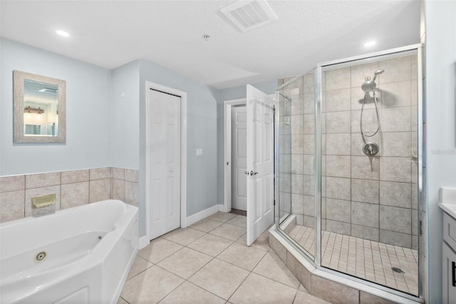 bathroom featuring vanity, tile patterned floors, independent shower and bath, and a textured ceiling