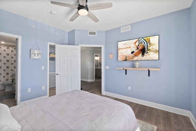 bedroom with wood-type flooring, ceiling fan, and ensuite bathroom