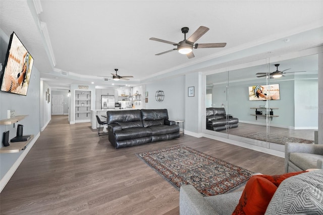 living room featuring wood-type flooring and a raised ceiling