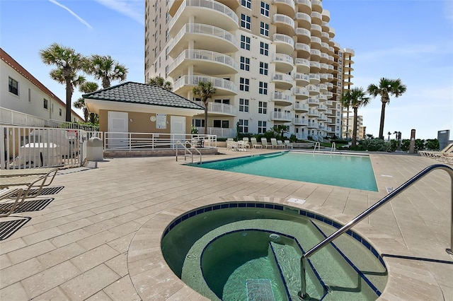 view of pool featuring a hot tub and a patio