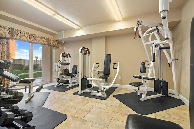 exercise area featuring light tile patterned flooring