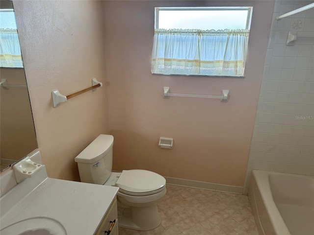 bathroom with toilet, baseboards, tub / shower combination, and vanity