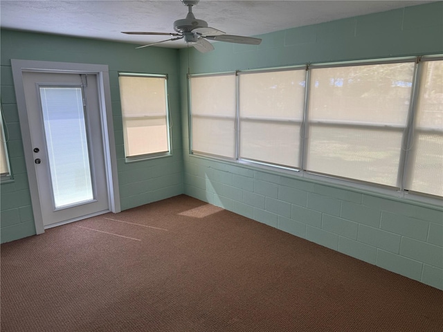 unfurnished sunroom with ceiling fan