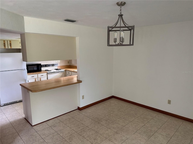 kitchen featuring a peninsula, white appliances, butcher block counters, visible vents, and an inviting chandelier