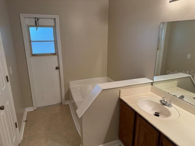 bathroom featuring vanity, tile patterned floors, and a bathtub