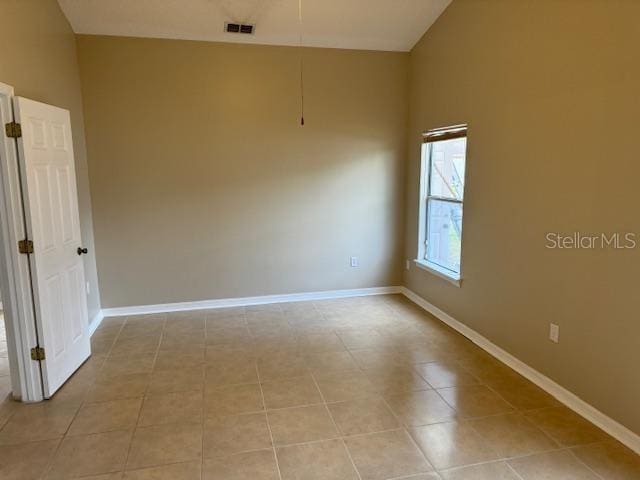 spare room with vaulted ceiling