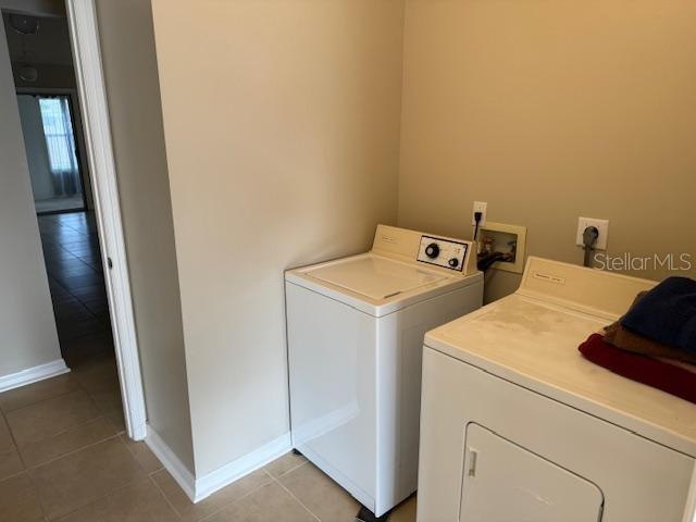 washroom with separate washer and dryer and light tile patterned floors