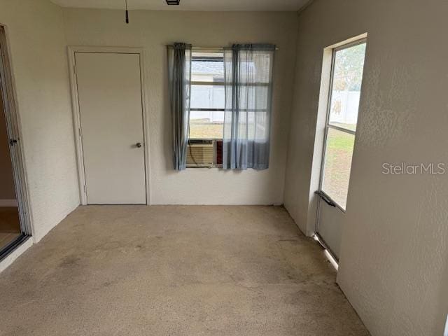 spare room with cooling unit and carpet floors