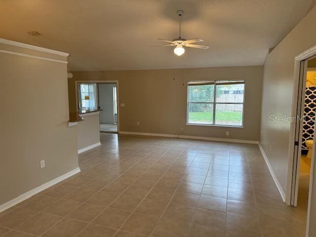 tiled spare room with vaulted ceiling and ceiling fan