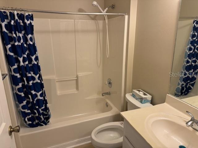 full bathroom featuring shower / bath combination with curtain, vanity, and toilet