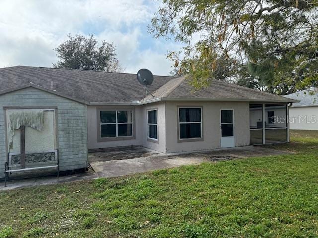 back of house featuring a yard and a patio